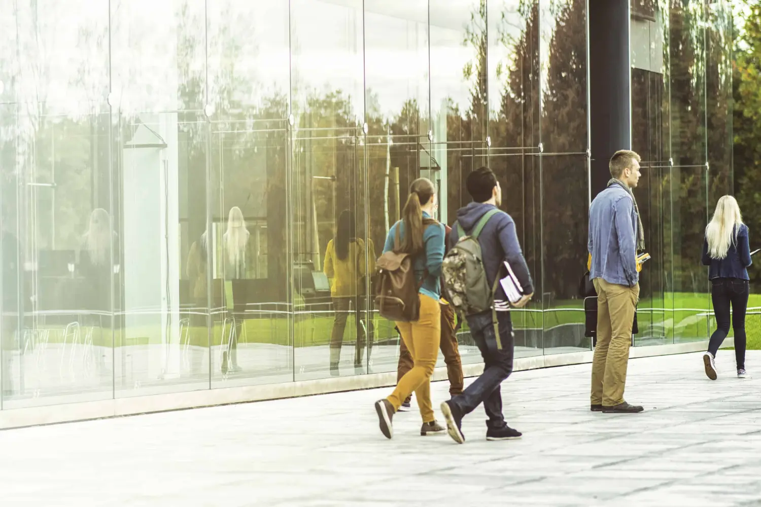 EMshield GmbH - Architecture and Corporate Security - This image depicts a group of students walking on a modern college campus.