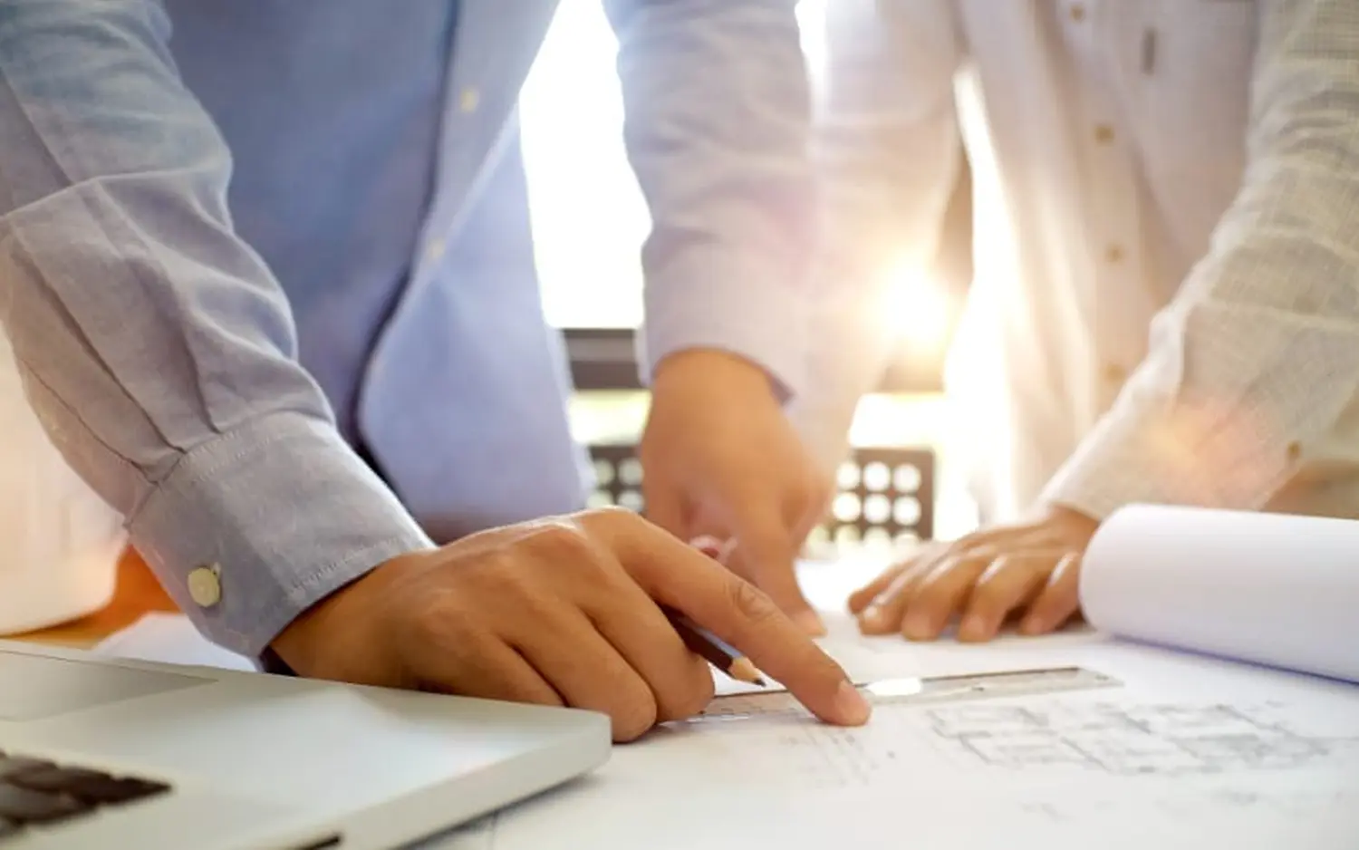 EMshield GmbH - Architecture and Corporate Security - a team of business professionals collaborating in an office environment, likely reviewing financial data, market trends, or startup metrics.